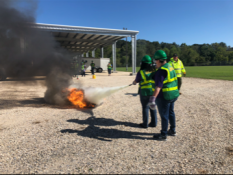 Two volunteers using a fire extinguisher