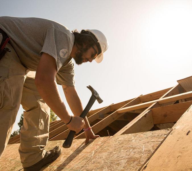 Man rebuilding a roof