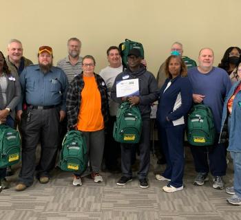 Ascension Parish CERT Team standing by a wall